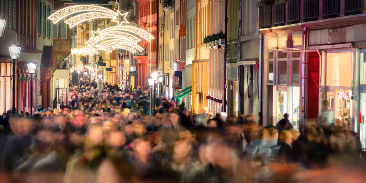 Large crowd of people hustling and shopping in a pedestrian area in Heidelberg, Germany, for Christmas